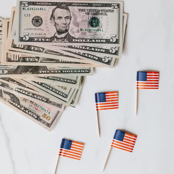 Dollar bills and small American flags
